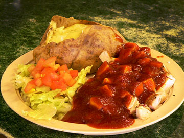 Smoked chicken plate with baked potato, salad and sauce